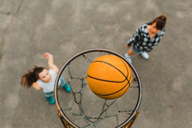 Top view with hoop of girls playing basketball
