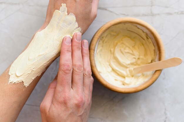 Top view of woman applying lotion on her hands