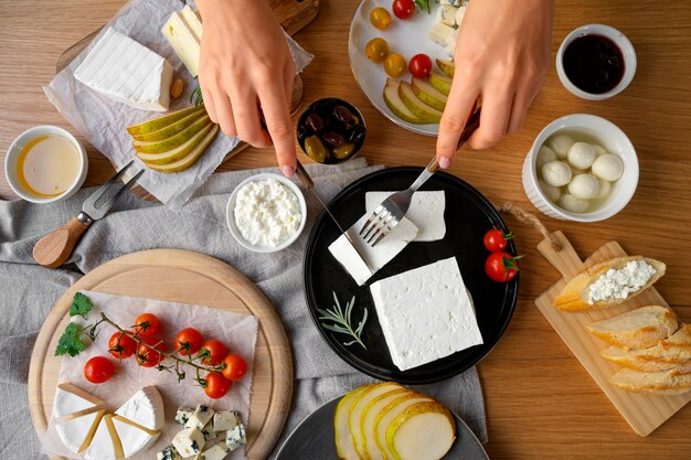 Top view woman cutting cheese