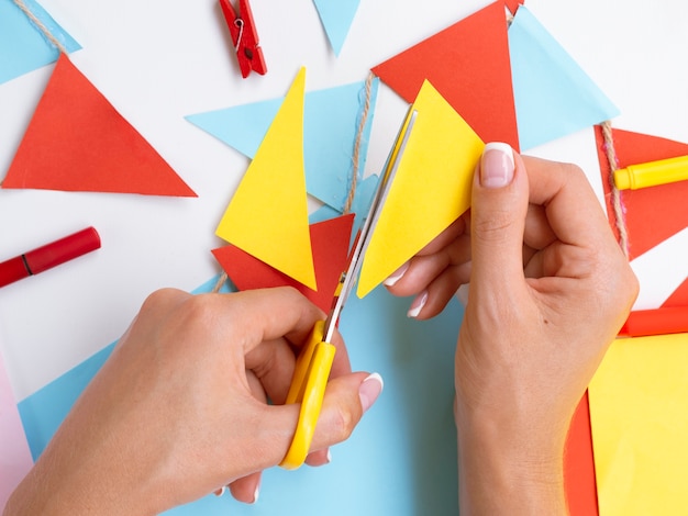 Top view of woman cutting colorful paper