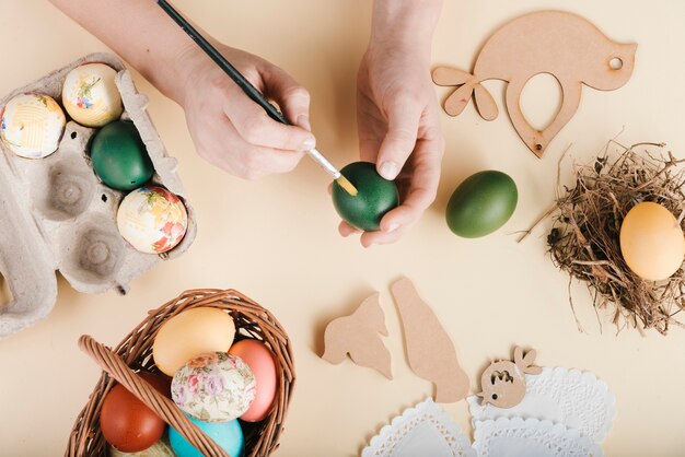 Top view of woman decorating easter eggs
