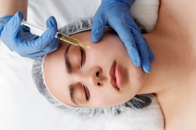 Top view woman getting face prp treatment