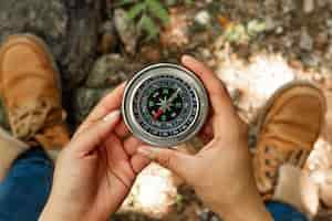 Free photo top view woman holding compass