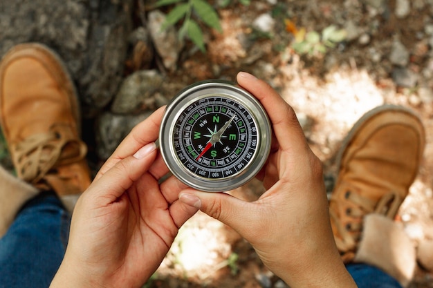 Top view woman holding compass