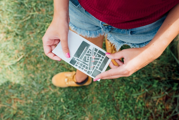 Top view of woman holding a directions card