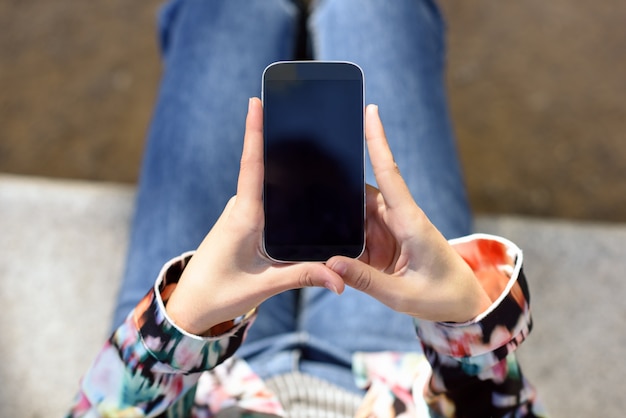 Top view of woman holding a mobile phone