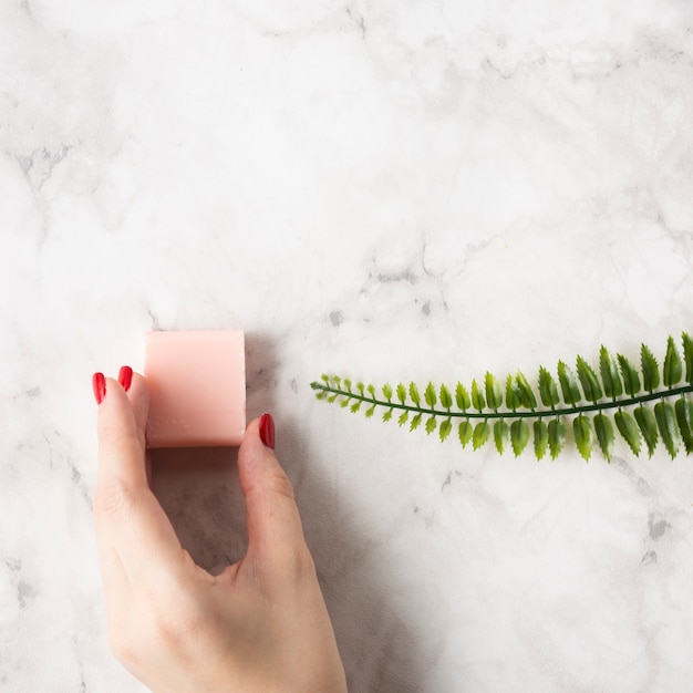 Free photo top view woman holding a pink soap