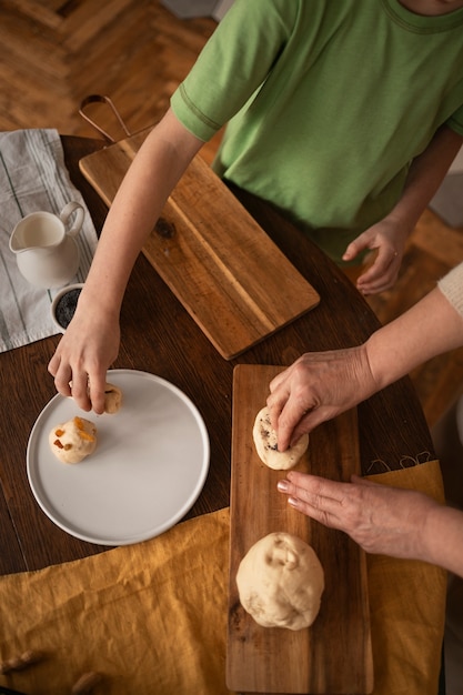 Free photo top view woman and kid preparing food