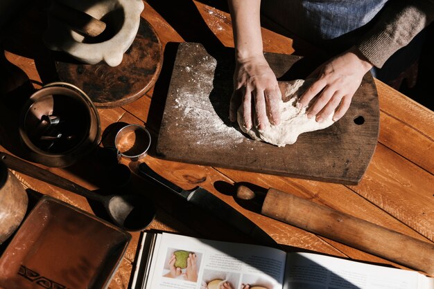 Top view of woman kneading dough