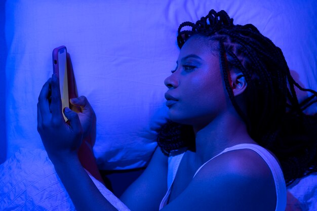 Top view woman laying with smartphone