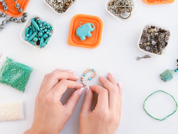 Top view of woman making colored accessories