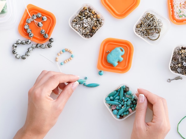 Top view of woman making colorful accessories