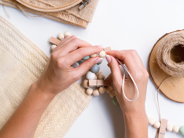 Top view of woman making wood decorations