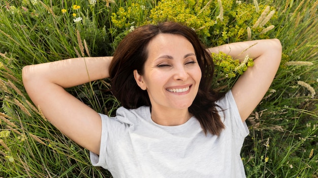 Top view of woman posing in grass outside