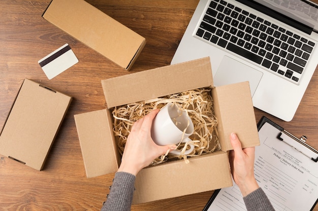 Free photo top view woman preparing a cyber monday package