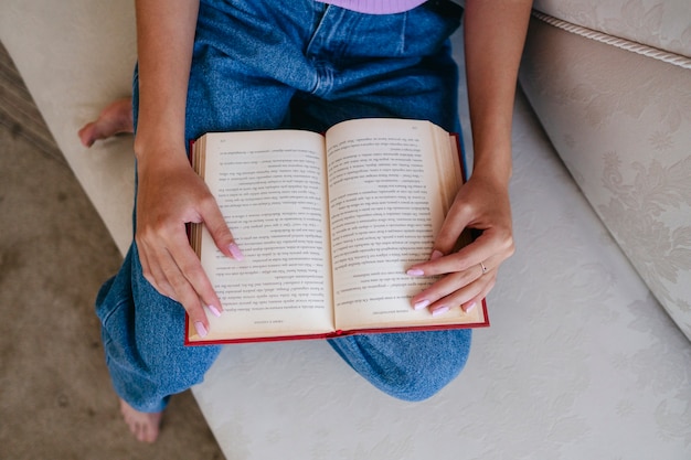 Free photo top view woman reading at home