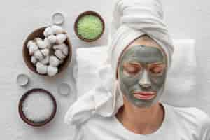 Free photo top view woman relaxing with face mask