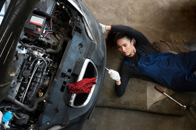 Top view woman repairing car