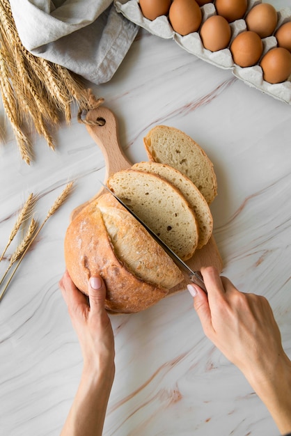 Top view woman slicing bread