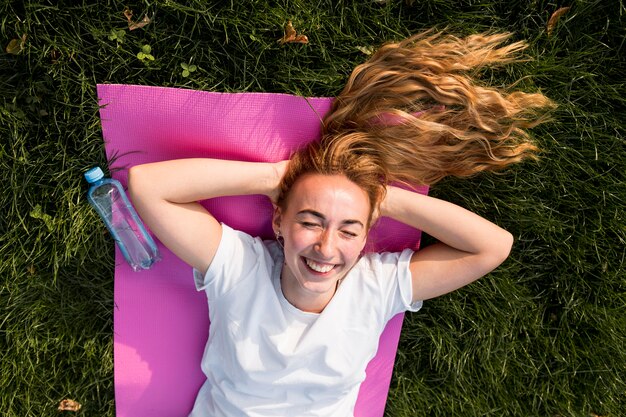 Top view woman in sportswear relaxing