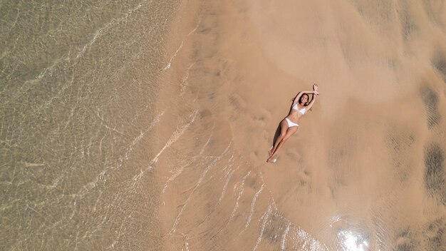 Top view woman tanning on the beach
