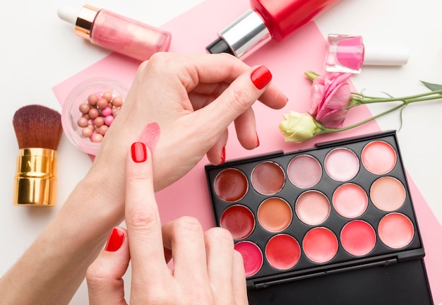 Top view woman trying make-up products