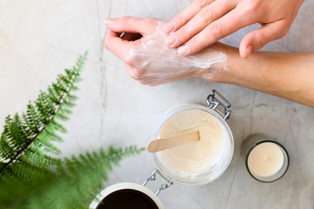 Top view of woman using cream on her hands