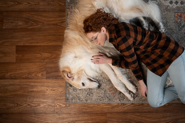 Free photo top view woman with cute greyhound dog