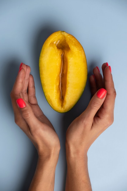 Free photo top view woman with mango