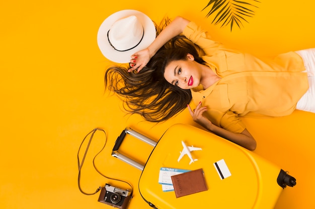Top view of woman with travel essentials
