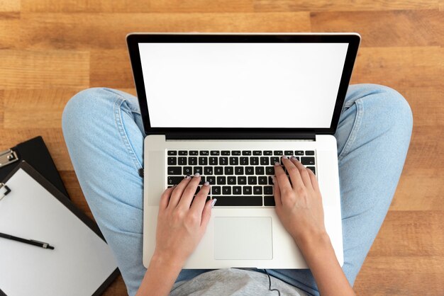 Top view of woman working at home during quarantine with laptop