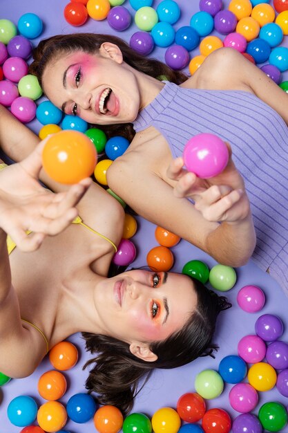 Top view women laying together on colorful balls