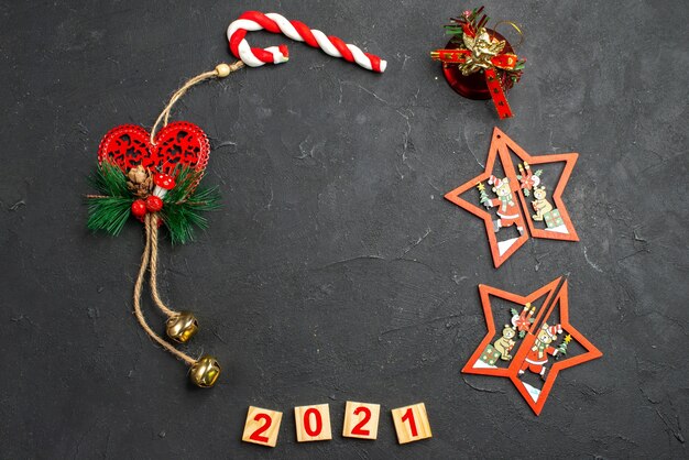 Top view wood blocks different xmas ornaments in a circle shape on dark isolated background free space