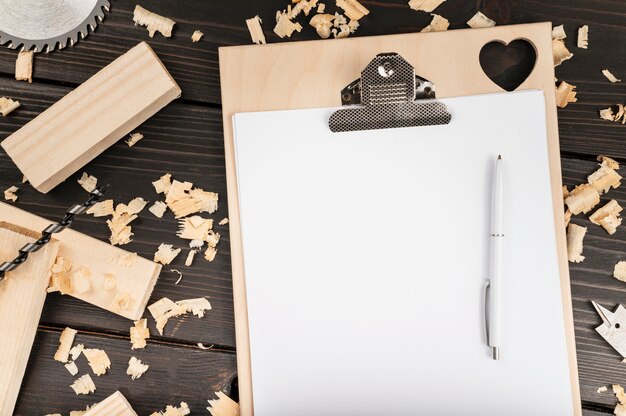 Top view wood tools on desk with clipboard