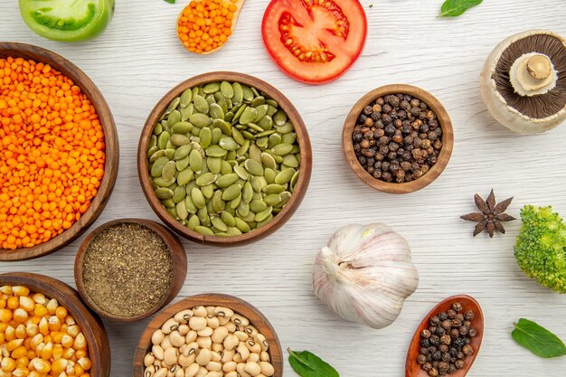 Top view wooden bowls with corn seeds black-eyed peas