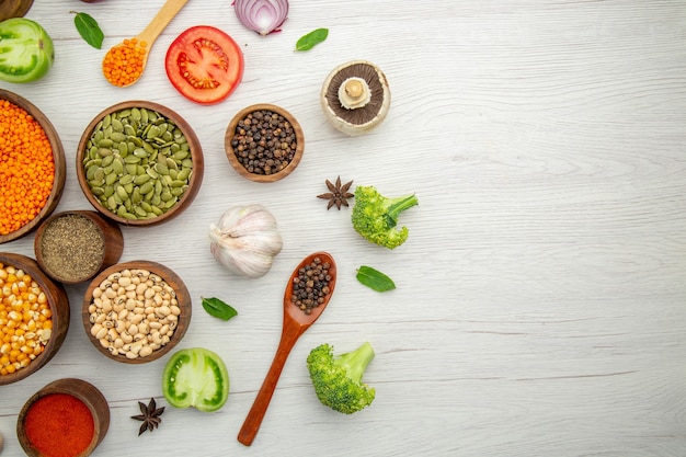 Top view wooden bowls with corn seeds on table with copy space