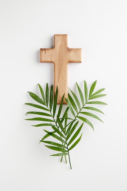 Top view wooden cross and leaves arrangement