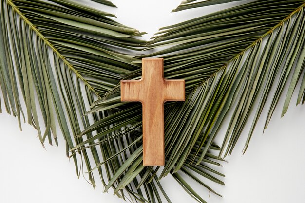 Top view wooden cross on leaves