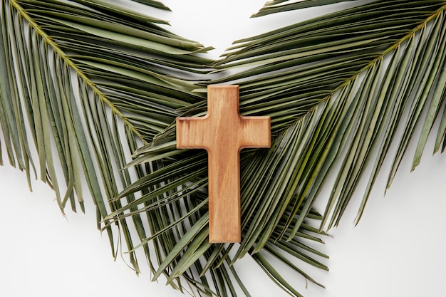 Top view wooden cross on leaves