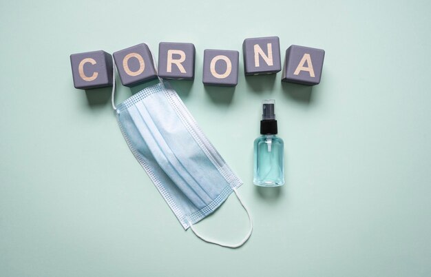 Top view of wooden cubes with corona and hand sanitizer