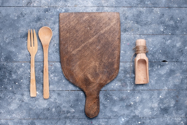 Top view wooden cutlery with brown wooden desk on the blue background spoon fork color photo kitchen