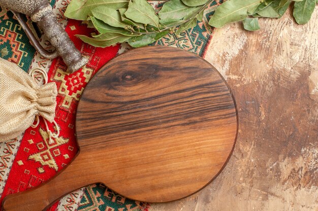 Top view of wooden desk with green leaves