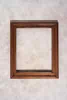 Free photo top view wooden frame on textured background