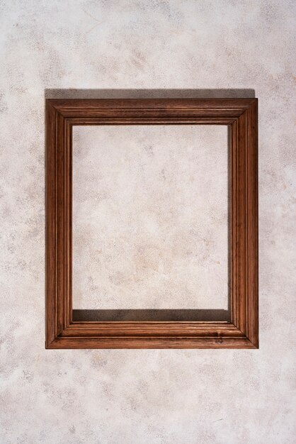 Top view wooden frame on textured background