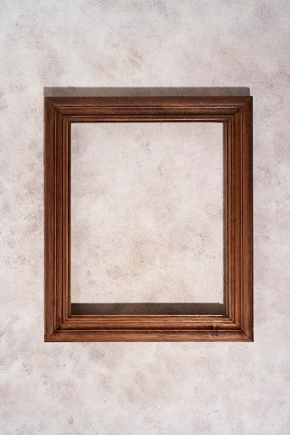 Top view wooden frame on textured background