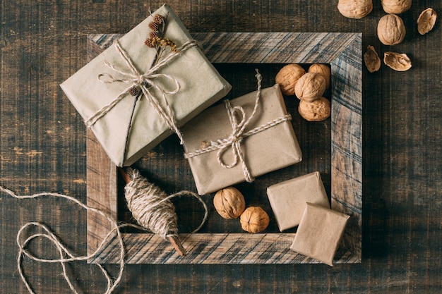 Top view wooden frame with presents and nuts