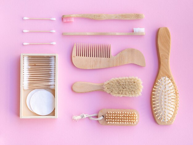 Top view wooden items on pink background