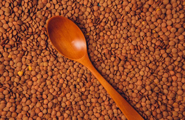Top view wooden spoon on lentils