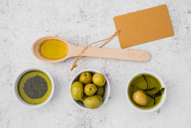 Top view wooden spoon with olives