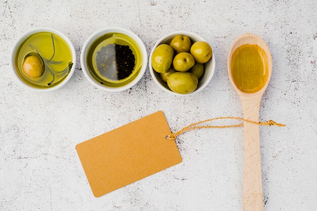 Top view wooden spoon with tasty olives